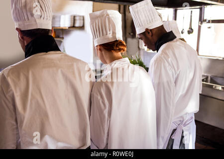 Chef working in kitchen at restaurant Stock Photo
