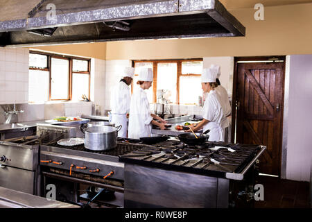 Chef working in kitchen at restaurant Stock Photo