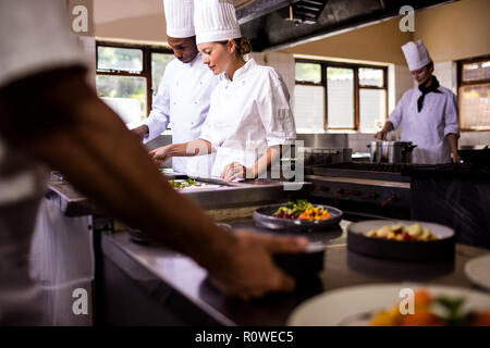 Chefs working in kitchen Stock Photo