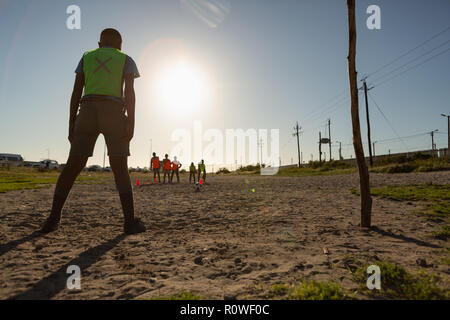 Kids playing football in the ground Stock Photo