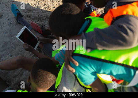 Kids using digital tablet in the ground Stock Photo