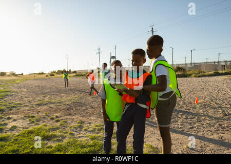 Kids using digital tablet in the ground Stock Photo