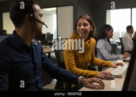 Customer service executives interacting with each other Stock Photo