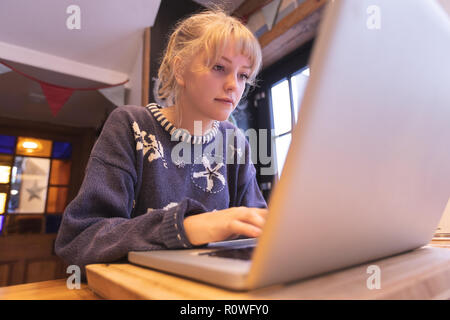 Woman using laptop at home Stock Photo