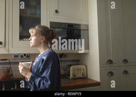 Woman having coffee at home Stock Photo