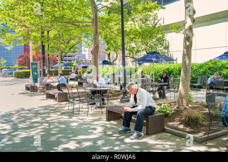 White collar workers relax in a park during work break Stock Photo