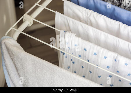 Laundry drying on the clotheshorse. Stock Photo