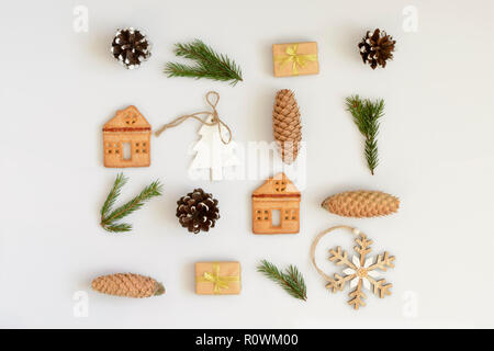 Creative Christmas layout made of winter things with present, cookies, coins on white background. Flat lay. Stock Photo
