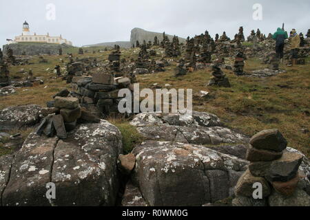 Isle of Skye, Scotland. Standing Cairn Stones, and Neist Point Lighthouse. Stock Photo