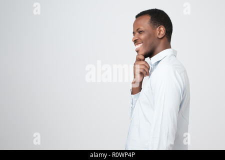 A side view of young handsome african man standing having excellent idea Stock Photo
