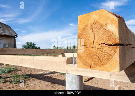 The pine board impregnated with an antiseptic on the frame basis of the house. Construction of the base of the A-type frame house. Stock Photo