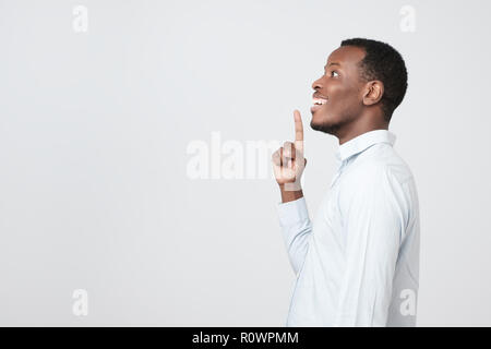 A side view of young handsome african man standing having excellent idea Stock Photo
