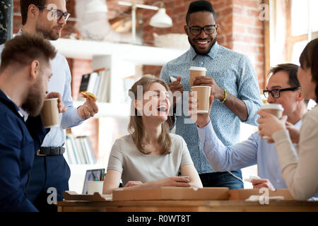 Happy diverse colleagues celebrate during lunch break in office Stock Photo