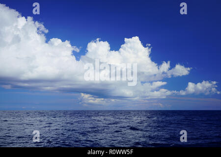 Cloudscape and deep blue waters of the Mediterranean Sea, off the coast of northern Majorca, Spain. Maritime open sea background. Stock Photo