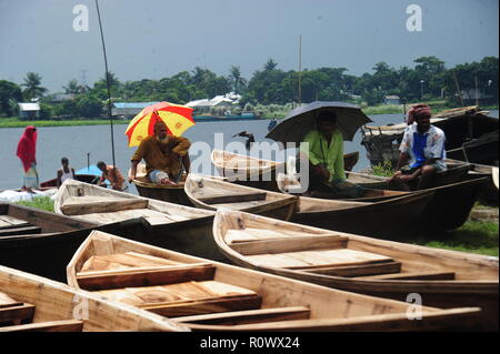 Boat makers display the wooden boat for sale at Kaikkarateke market , Narayanganj district in Bangladesh. On June 21, 2015 Boat makers at the weekly “ Stock Photo