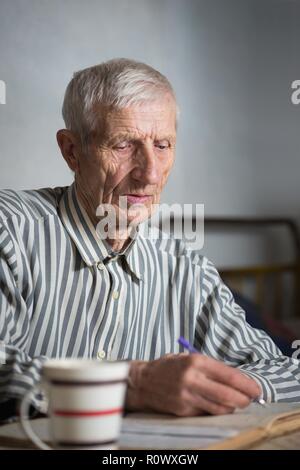 pensioner. portrait of  senior man writing in a notebook Stock Photo