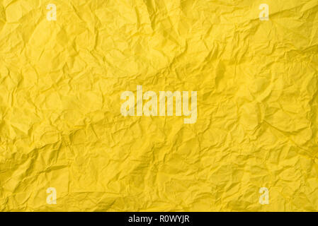 yellow crumpled paper texture as background. concept of school, abstract and stress Stock Photo