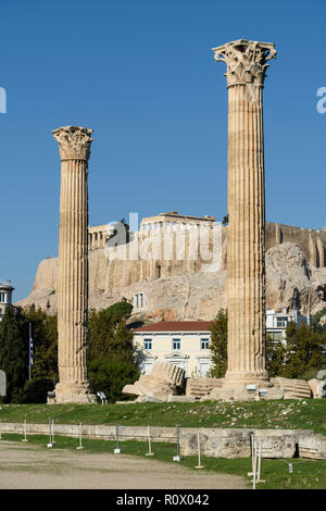 Athens. Greece. Corinthian columns of the Temple of Olympian Zeus (Olympieion) with the Parthenon and Acropolis in the background. Stock Photo