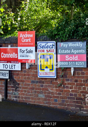 Row of To Let and For Sale Estate Agent or Real Estate Boards, UK 