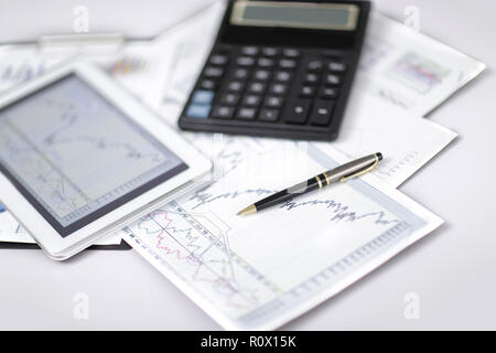 close up. pen, financial chart and digital tablet on the Desk Stock Photo