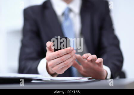 close up.businessman typing text message on smartphone Stock Photo