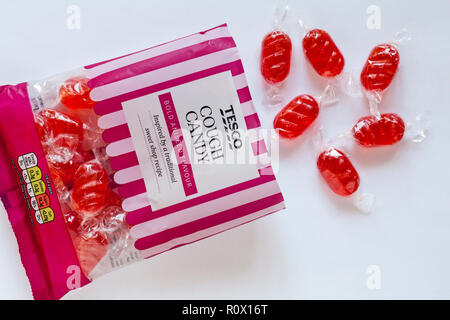 Packet of Tesco Cough Candy bold aniseed flavour sweets inspired by a traditional sweet shop recipe opened with contents spilt set on white background Stock Photo