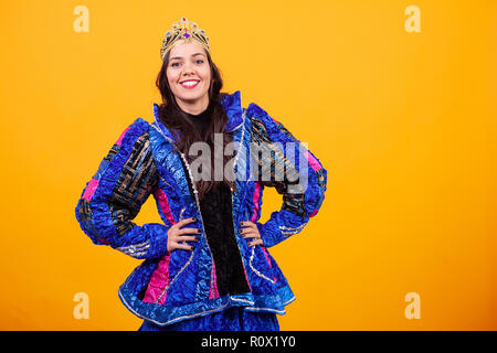 Beautiful young woman wearing inovatine costume over yellow background in studio Stock Photo