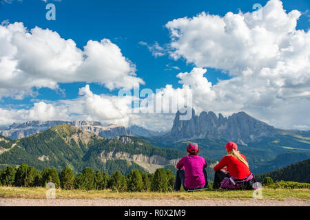 Sporty Young woman friends on mountain trail Dolomites Mountains, Italy Stock Photo