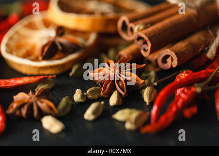 Different spices and herbs on a black slate. Stock Photo