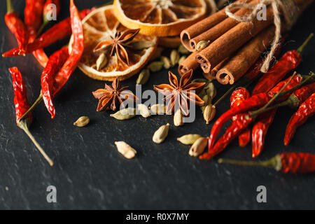 Different spices and herbs on a black slate. Stock Photo