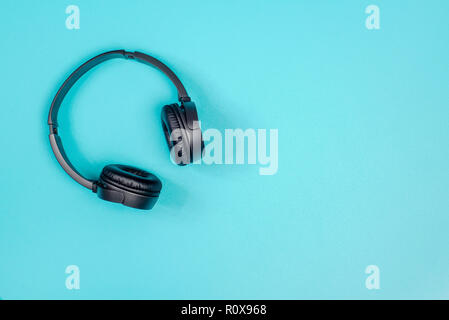 Black headphone on pastel green metal table background Stock Photo