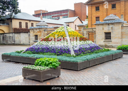 Pyramid shaped flower bed in Macquarie Street in front of Hyde Park Barracks Museum Sydney NSW Australia. Stock Photo