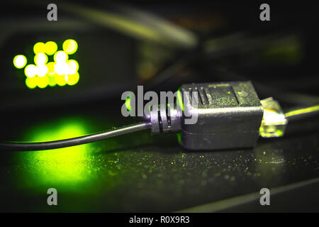 A connected Ethernet cable with a working switch in the background Stock Photo
