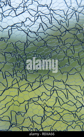 Interlacing threads. Mesh woven from black and blue threads on blue and green background. abstract texture Stock Photo