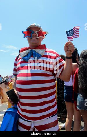 a man in stars and stripes outfit waves an american flag at coney island nathans hot dog eating competition 2017 Stock Photo