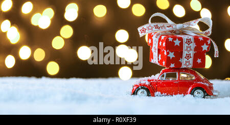 Red retro toy car delivering Christmas or New Year gifts Stock Photo