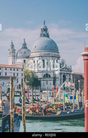 Venetian gondolas with the Basilica di Santa Maria della Salute in the background. Venice, Italy