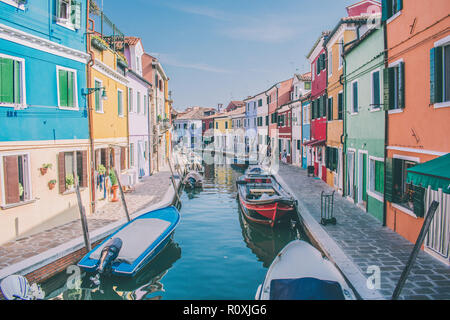 Boats in front of colourful houses in Burano, Venice, Italy Stock Photo