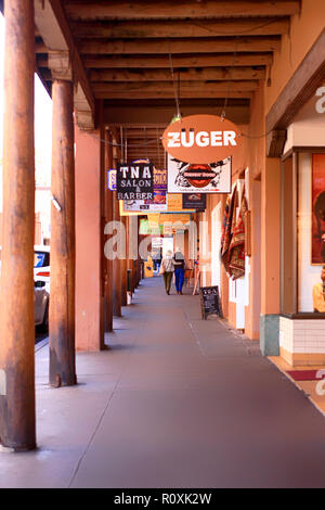 Overhead store signs above the sidewalk along W. San Francisco Street in downtown Santa Fe, New Mexico USA Stock Photo