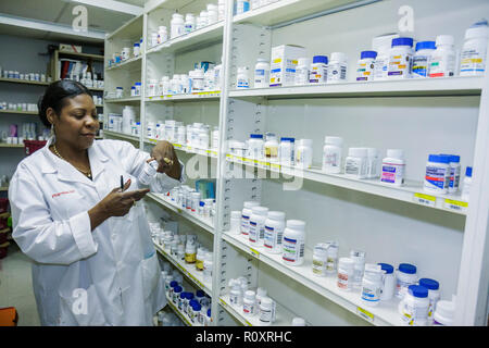 Miami Florida,Borinquen Health Care Center,clinic,pharmacist,dispensing chemist,health professional,Black woman female women,medicines,drugs,bottles,f Stock Photo