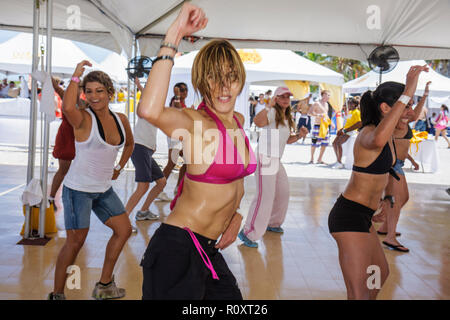 Miami Beach Florida,fitness class exercising Latin Fusion Zumba,Hispanic woman female women,cardio workout sweating aerobic session group trainer Stock Photo