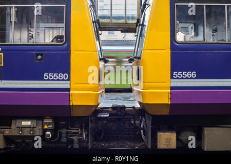 2 Northern rail pacer trains at Preston nose to nose while another train departs behind Stock Photo