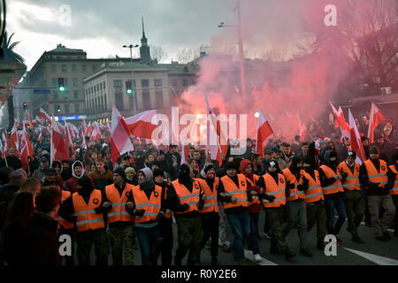 Huge crowds seen marching in the streets with reflector jackets during the demonstration. Last year about 60,000 people took part in the nationalist march marking Poland’s Independence Day, according to police figures. The march has taken place each year on November 11th for almost a decade, and has grown to draw tens of thousands of participants, including extremists from across the EU. Warsaw’s mayor Hanna Gronkiewicz-Waltz has banned the event. Organizers said they would appeal against the decision, insisting they would go ahead with the march anyway and raising the prospect of a showdown b Stock Photo