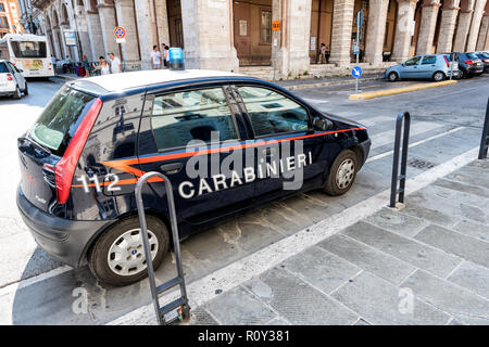 Perugia, Italy - August 29, 2018: Small Carabinieri car parked on street, road by sidewalk with old, ancient, antique architecture, building, people,  Stock Photo