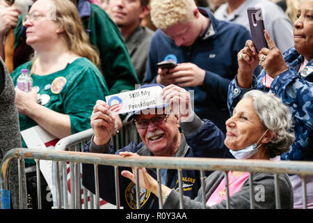 A man holds a 'Still My President' sign in a crowd during a rally that former president Barack Obama speaks at in Milwaukee, Wisconsin. Stock Photo
