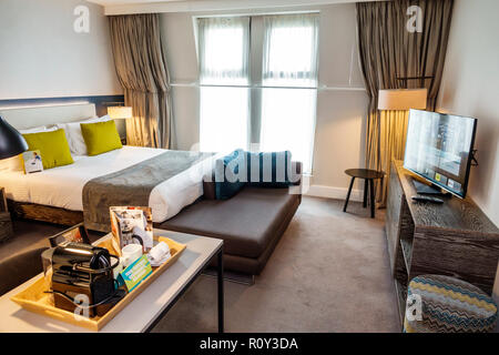 London England,UK,Lambeth,Staybridge Suites London Vauxhall,hotel,guest room,bed,desk,clean room,coffee maker tray,contemporary decor,flat screen TV t Stock Photo