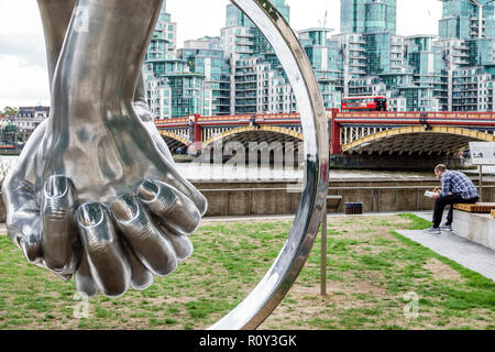 London England,UK,Westminster,Riverside Walk Gardens,Love by Lorenzo Quinn,sculpture,giant hands,chrome metal,view of Vauxhall Bridge,Thames River,cit Stock Photo