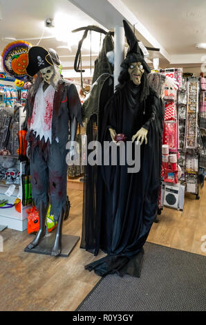 Seasonal Fancy Dress costumes for sale at Halloween one depicting a pirate and the other a witch Stock Photo