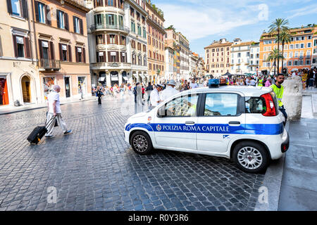 Rome, Italy - September 4, 2018: Small Police car parked on street, road in Piazza di spagna with old, ancient, antique architecture, building, people Stock Photo