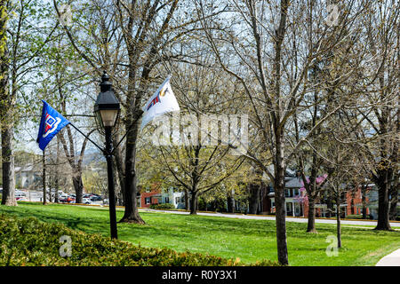 Lexington, USA - April 18, 2018: Washington and Lee University hall sidewalk in Virginia exterior facade during sunny day with nobody, flags Stock Photo